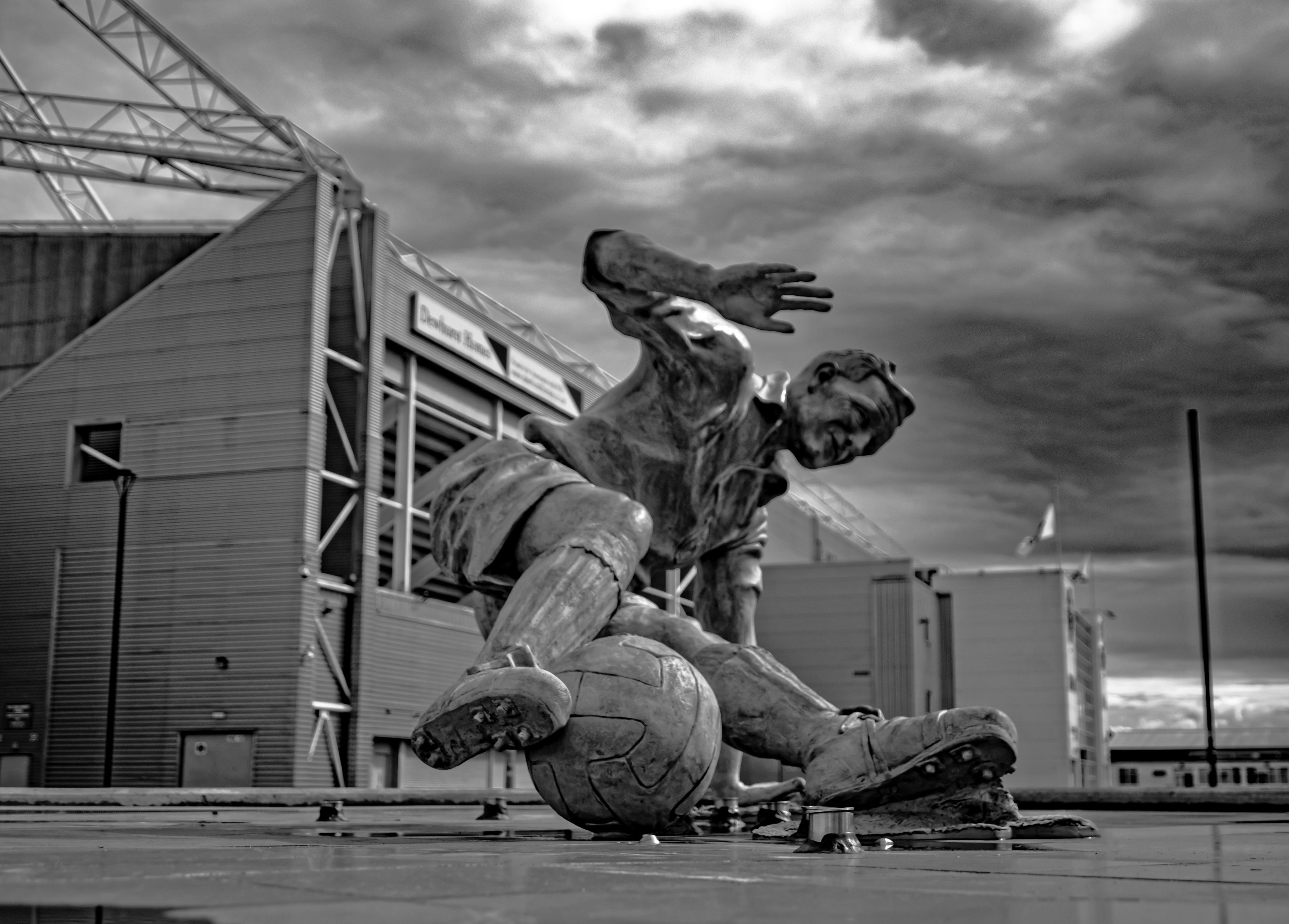 A man riding a skateboard on top of a cement floor